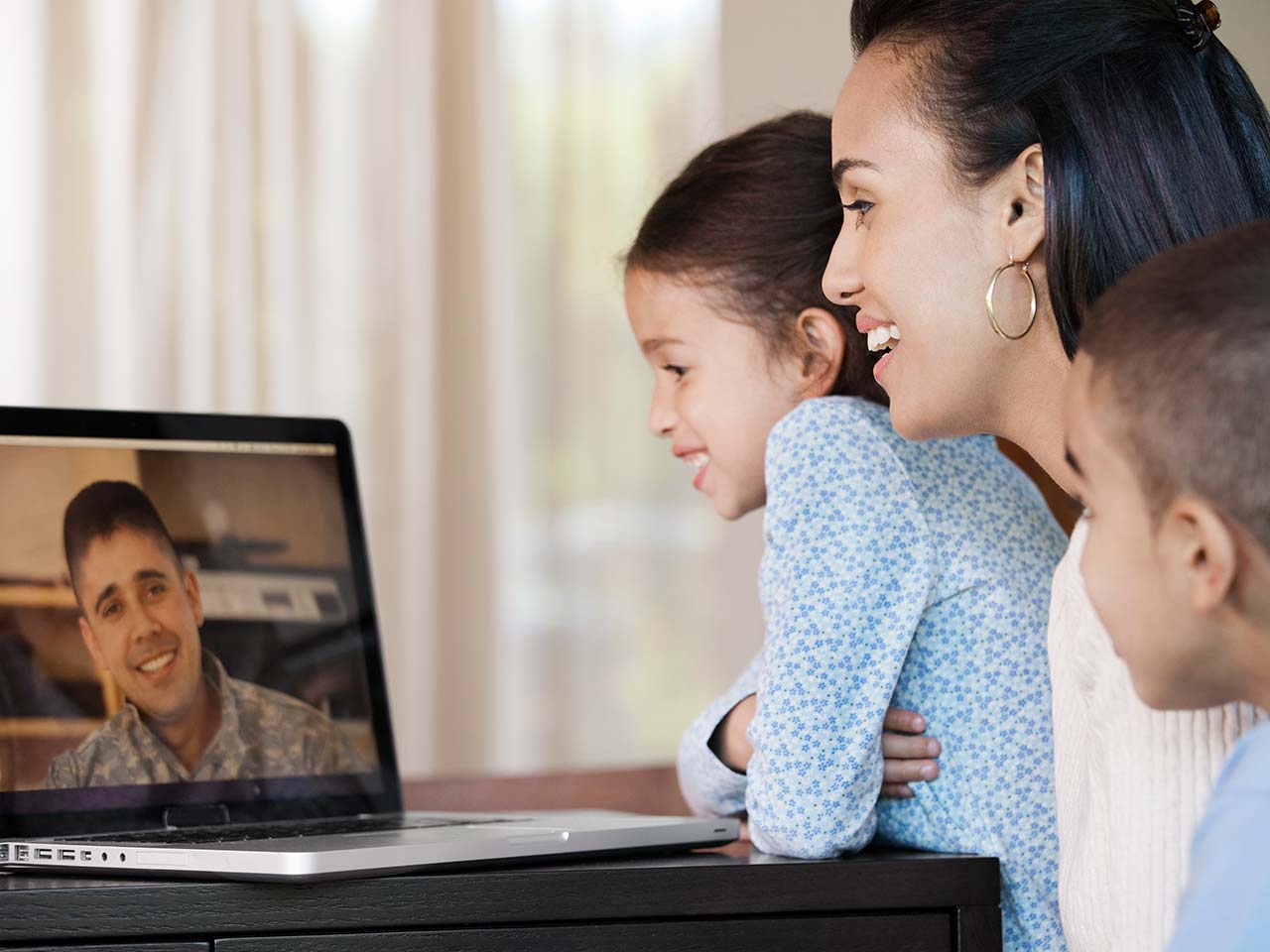 Family having video chat with military father 